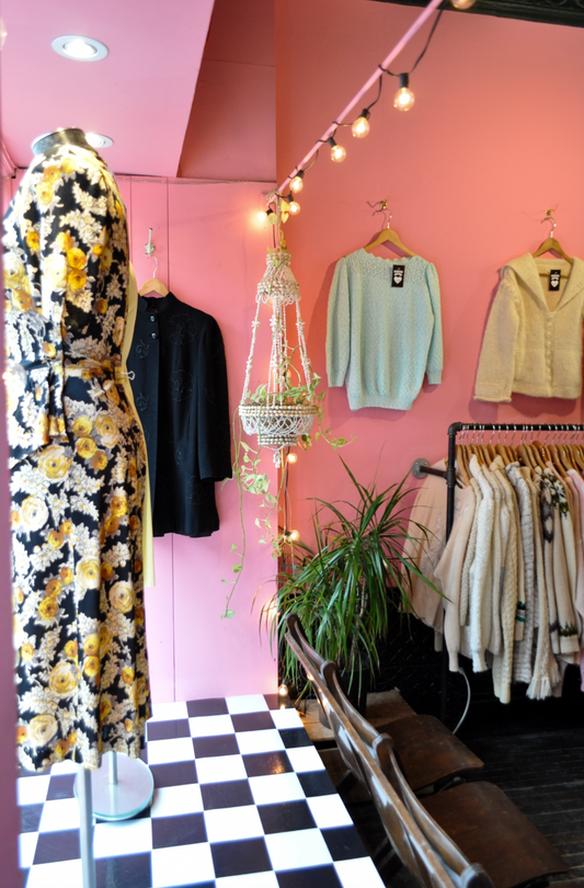 pink walls with pastel coloured clothing hanging
